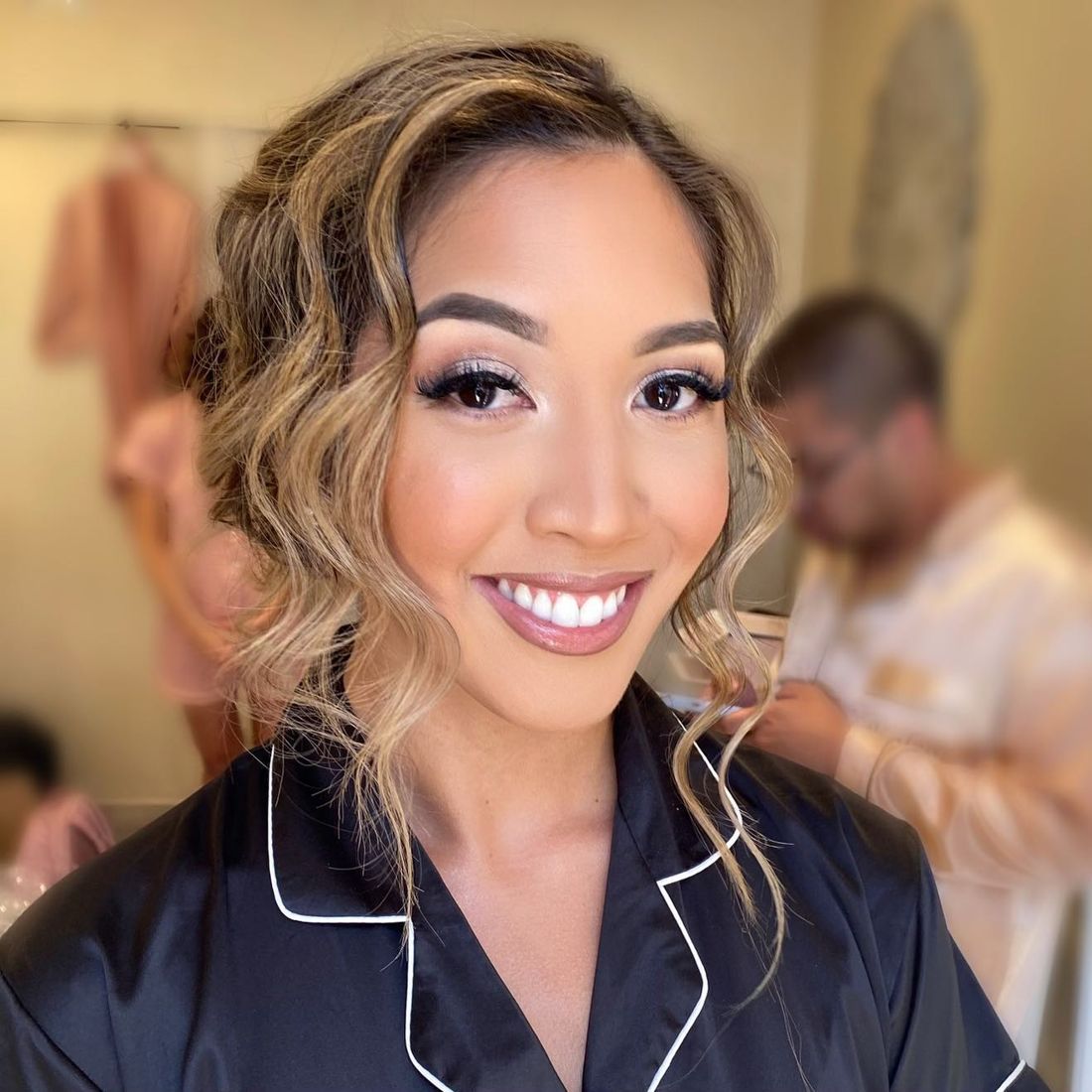 Bride with glam makeup and a soft updo with face-framing curls