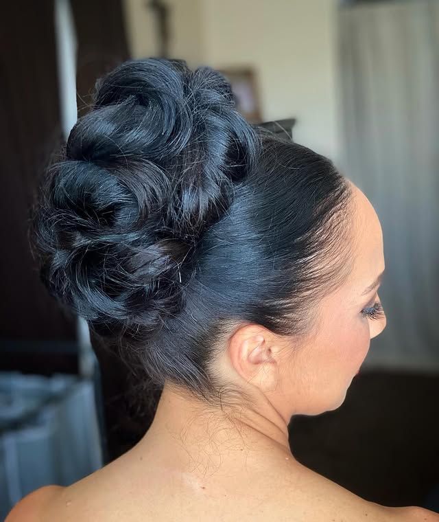 Voluminous curled updo on dark hair